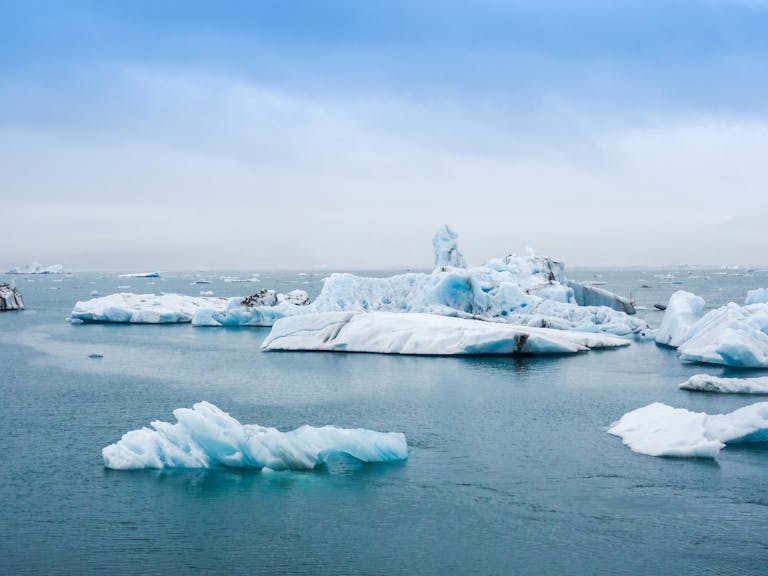 Climate Change, Serene view of icebergs floating in the calm waters of Jokulsarlon Lagoon, Iceland.