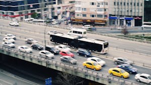 Aerial view of city traffic with cars and a metrobus on a busy roadway.